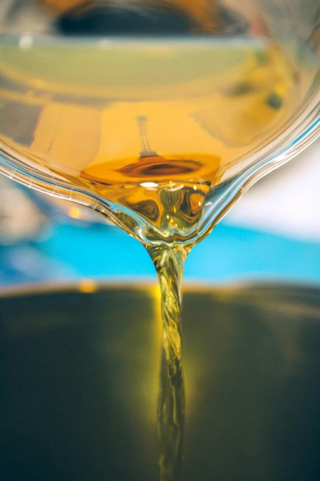 Golden crude soybean oil being poured